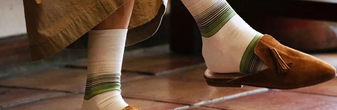 Mans Feet Wearing a Pair of Rototo Socks and Slippers